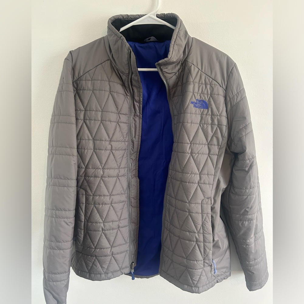 North Face (L) Women’s lightweight jacket. Gray with royal blue interior, logo.